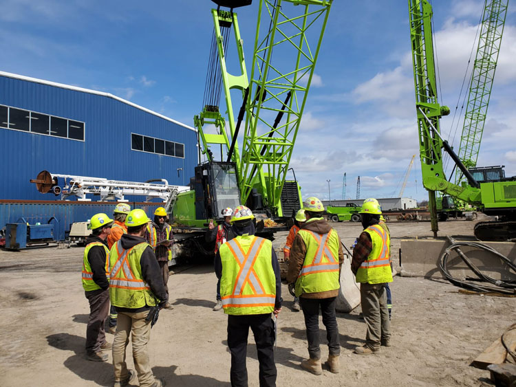 Men in safety huddle on site